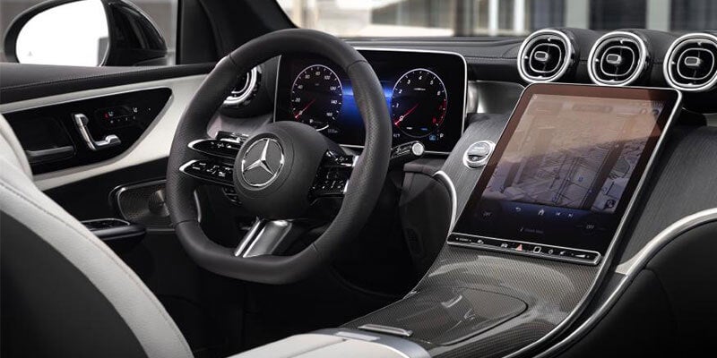 Modern Mercedes-Benz interior featuring a digital instrument cluster, multifunction steering wheel, and touchscreen display