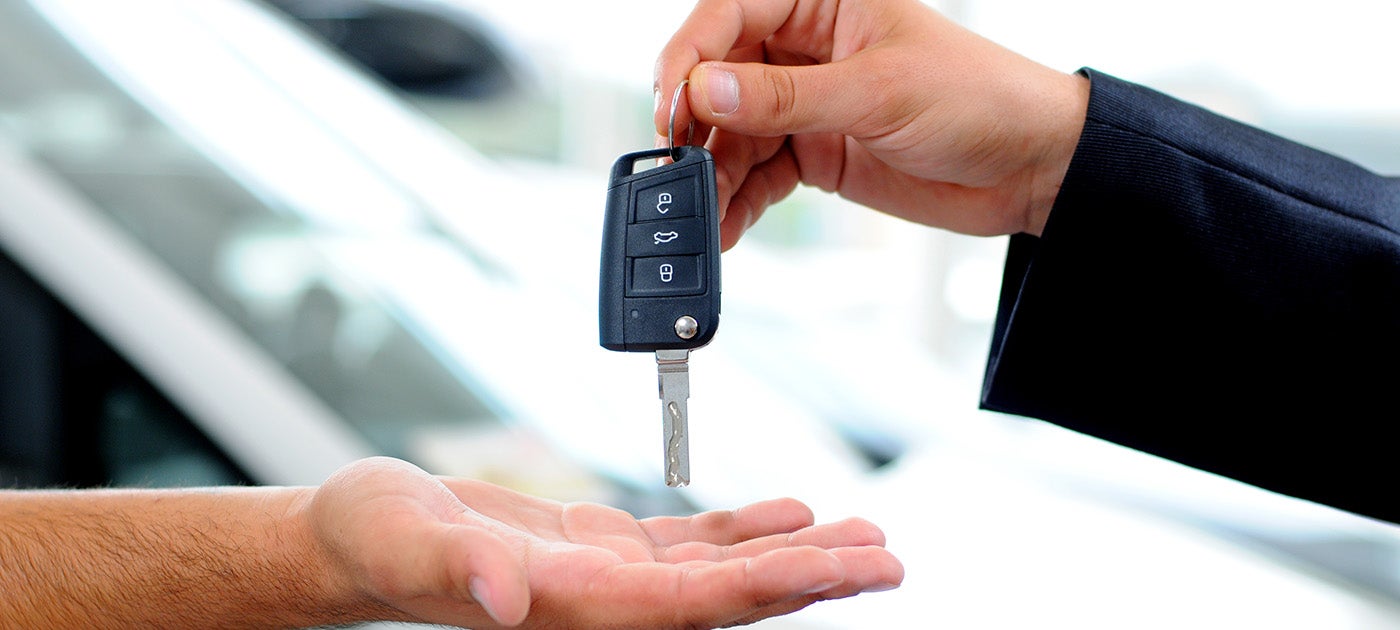 Sales consultant handing the keys to a new Mercedes-Benz